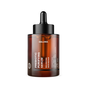 Eine Tropfflasche aus braunem Glas mit der Aufschrift DALUMA PREBIOTIC PURIFYING GESICHTSSERUM ist mit weißem Text versehen, der "Hautbarriere-stärkende und Unreinheiten reduzierende Eigenschaften" hervorhebt, und wird mit einem schwarzen Tropfverschluss geliefert.